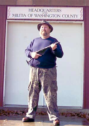 Wayne Fincher holding a 9mm Mark III Sten machine carbine